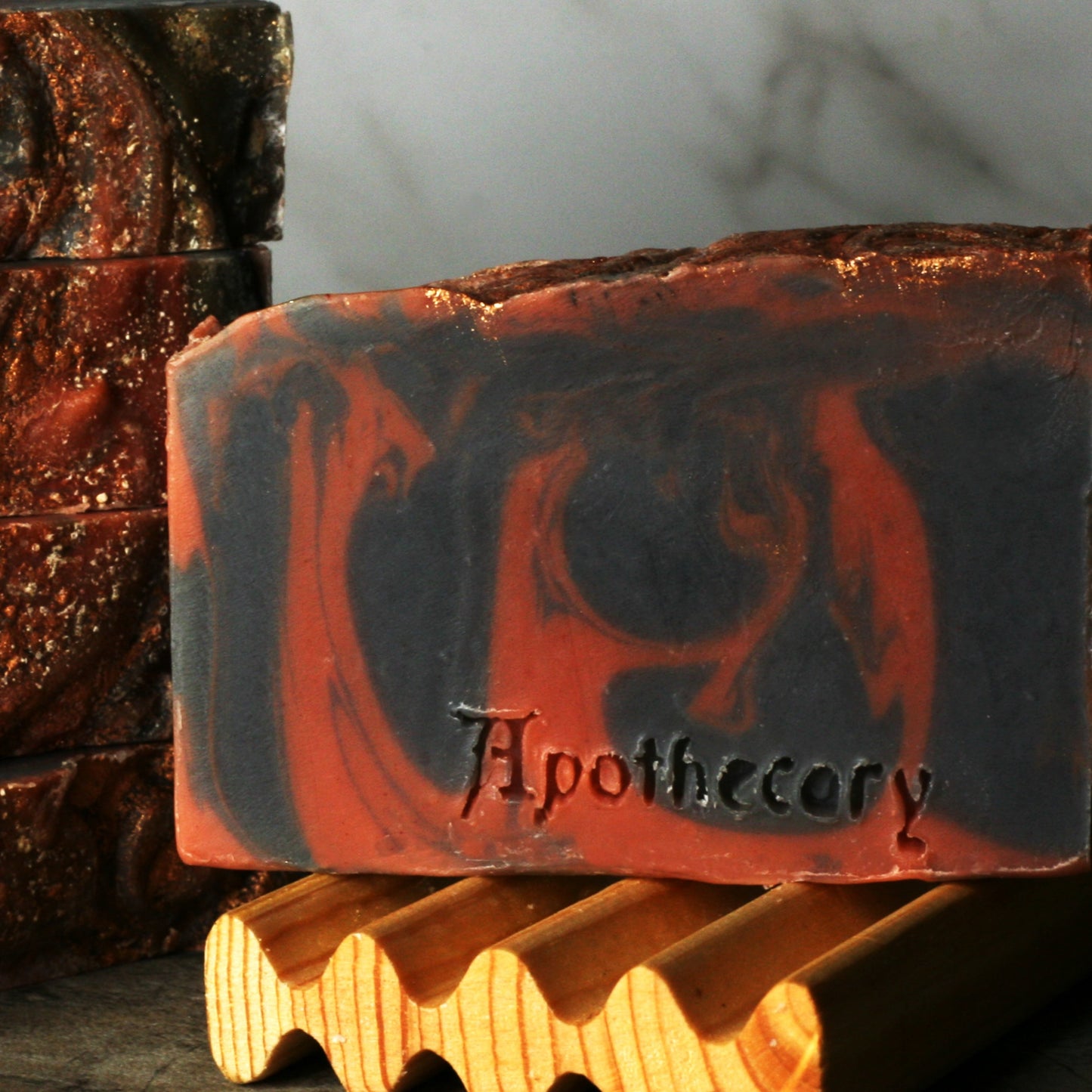 black and red swirled soap with copper sparkles and dragons blood scent. handmade bar soap