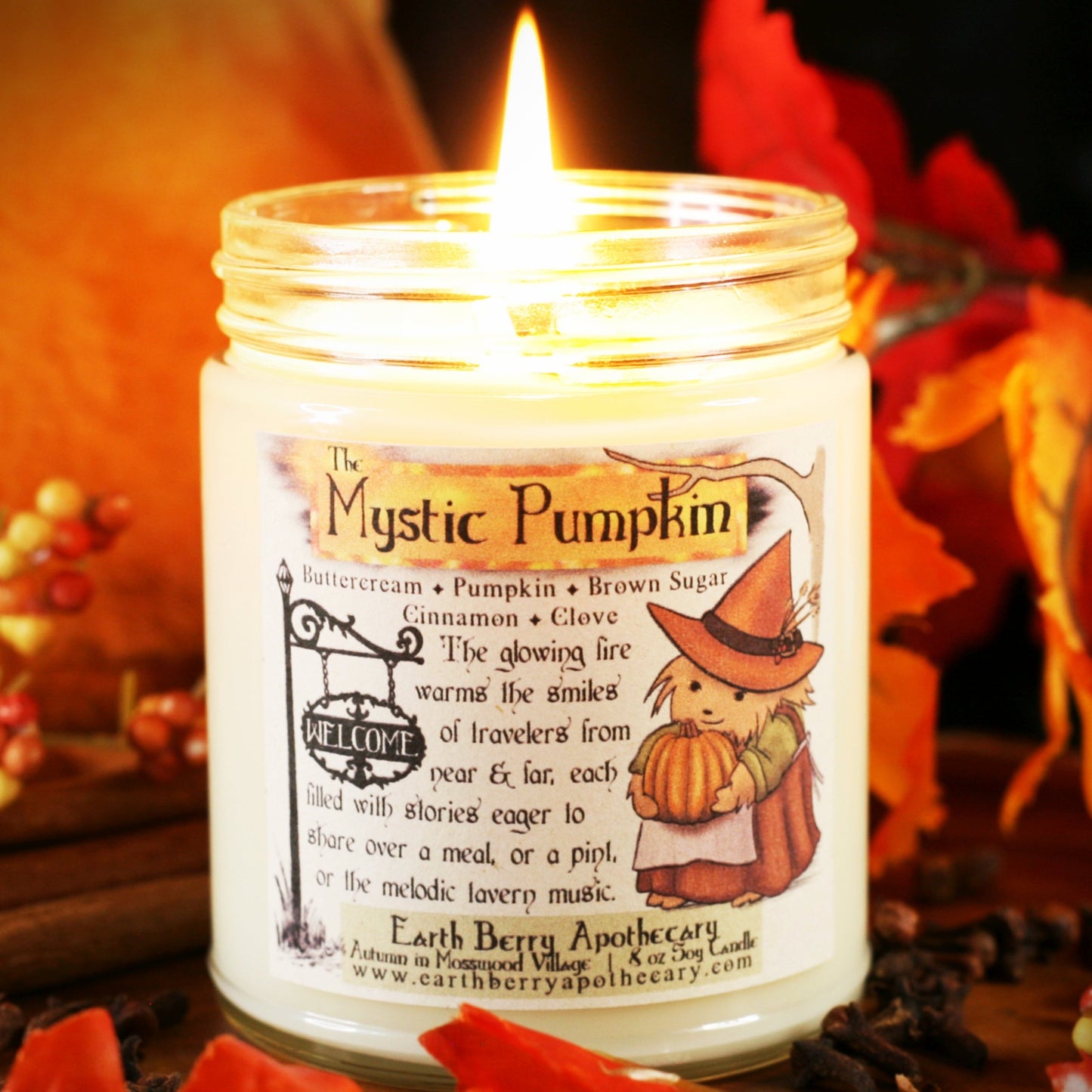 The mystic pumpkin soy candle is the best pumpkin spice of the year with cinnamon clove buttercream and a cute hedge witch hedgehog holding a pumpkin and wearing an orange harvest hat