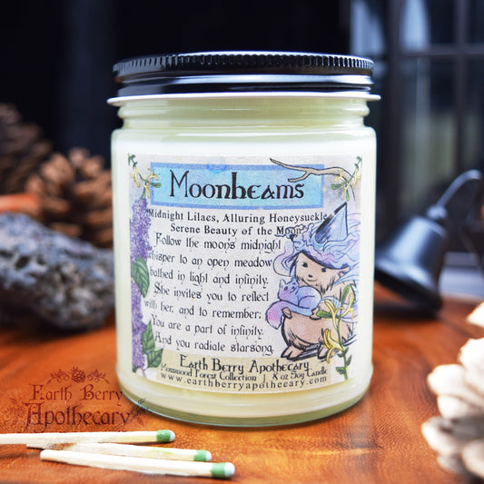 Lilac and honeysuckle scented candle with harmony hedge witch holding the ethereal moon cat