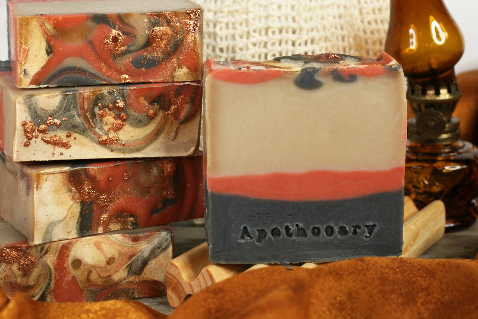 Black, red, and beige layers make this sensual, musky soap vivid and fiery. The top has black, red, and sparkling copper swirls