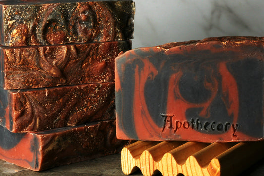 black and red swirled soap with copper sparkles and dragons blood scent. handmade bar soap