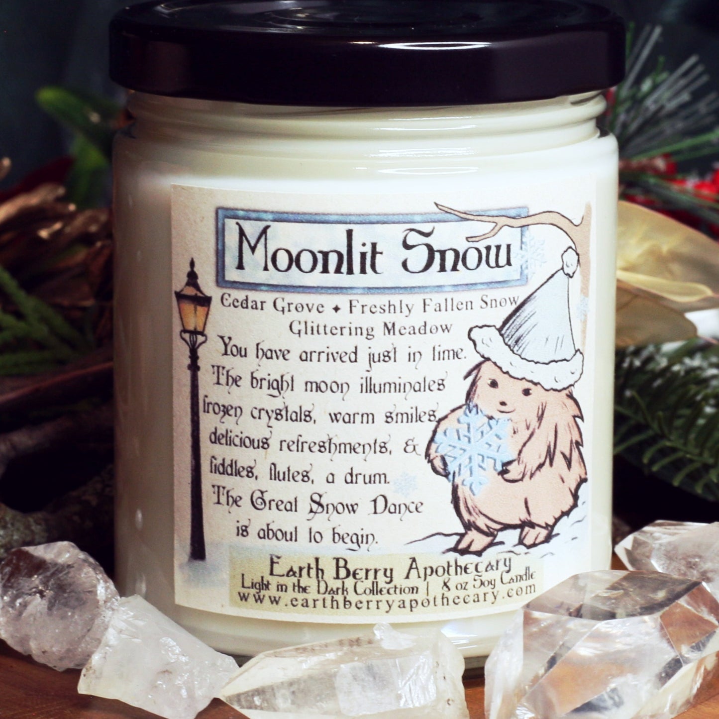 Moonlit snow winter scented soy candle. Pine and cedar with snowy branches. The hedge witch holds a snowflake.