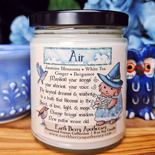 Candle jar labeled 'Air' with a witch-themed design on a wooden surface.