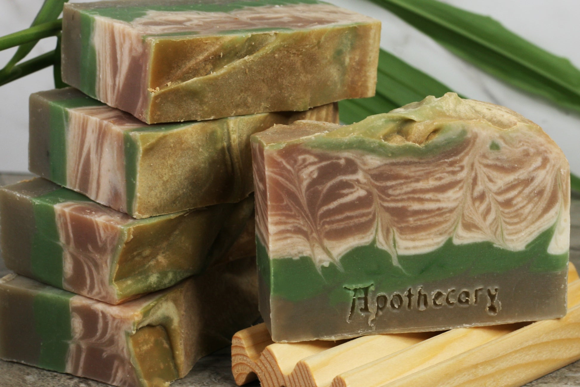 Coconut and bamboo handmade artisan soap with white, beige, and green swirls.