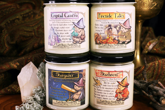 Set of 4 summer soy candles, nontoxic and clean burning. Crystal Cavern, Fireside Tales, Stargazers, and Starbrew are stacked and sitting in front of a fantasy background. Each label has the hedge witch doing her daily life