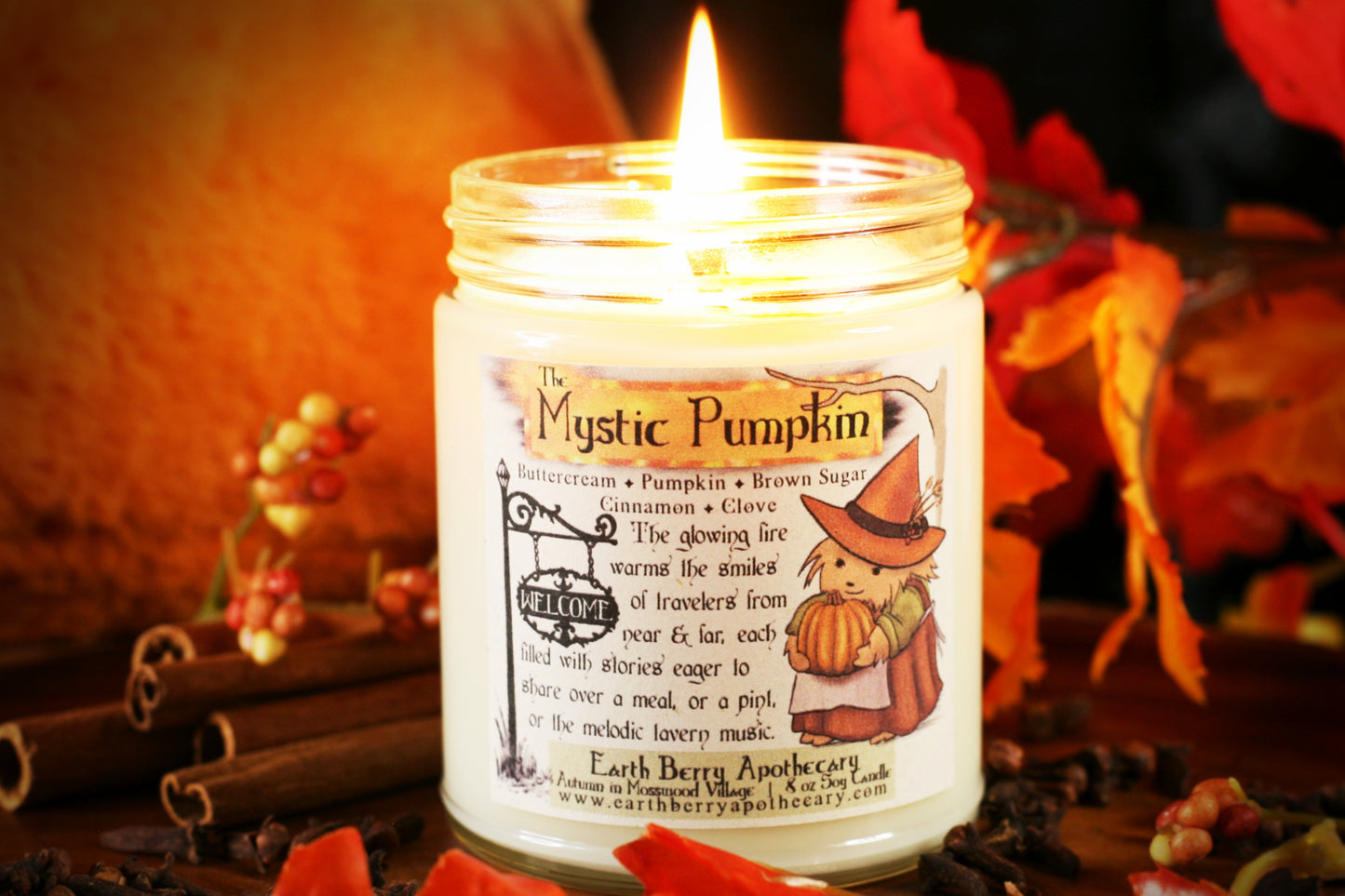 The mystic pumpkin soy candle is the best pumpkin spice of the year with cinnamon clove buttercream and a cute hedge witch hedgehog holding a pumpkin and wearing an orange harvest hat