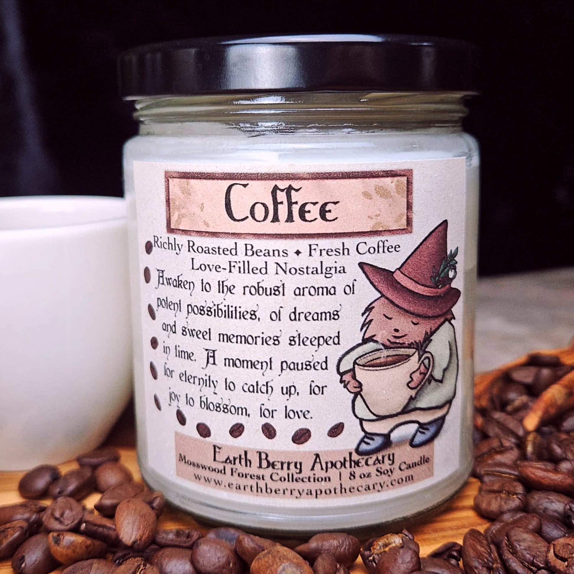 Candle jar labeled 'Coffee' with a cartoon hedgehog wearing a witch hat and clothes on a background of coffee beans and a cup.
