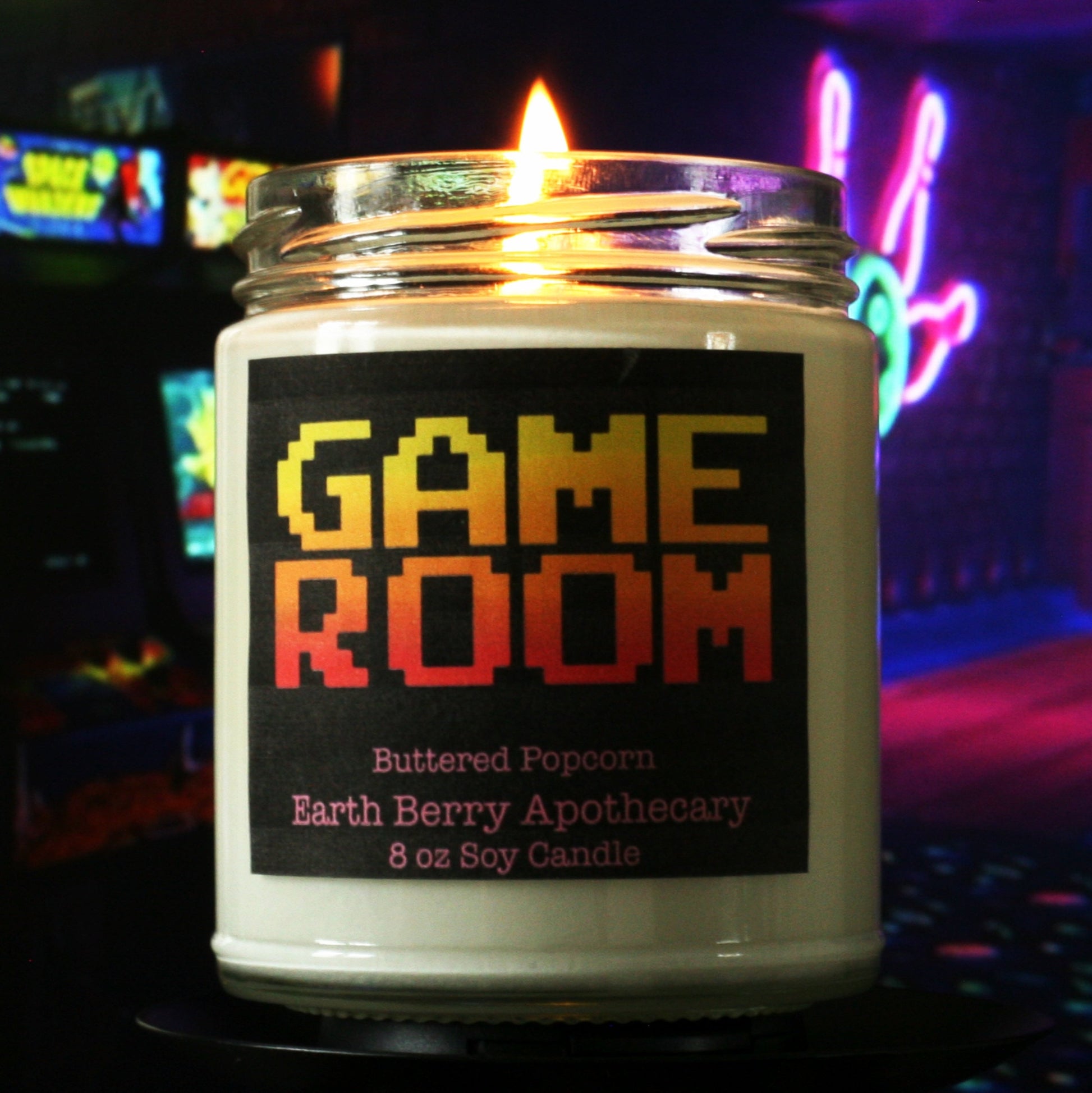 video game room candle in front of arcade machines