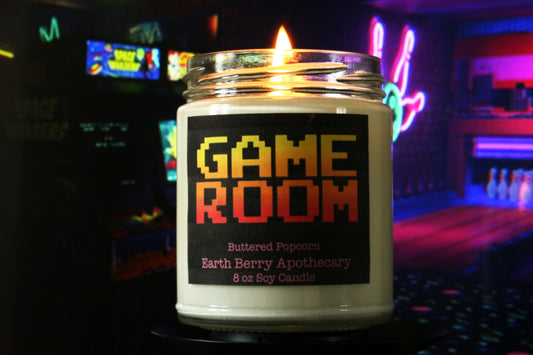 video game room candle in front of arcade machines