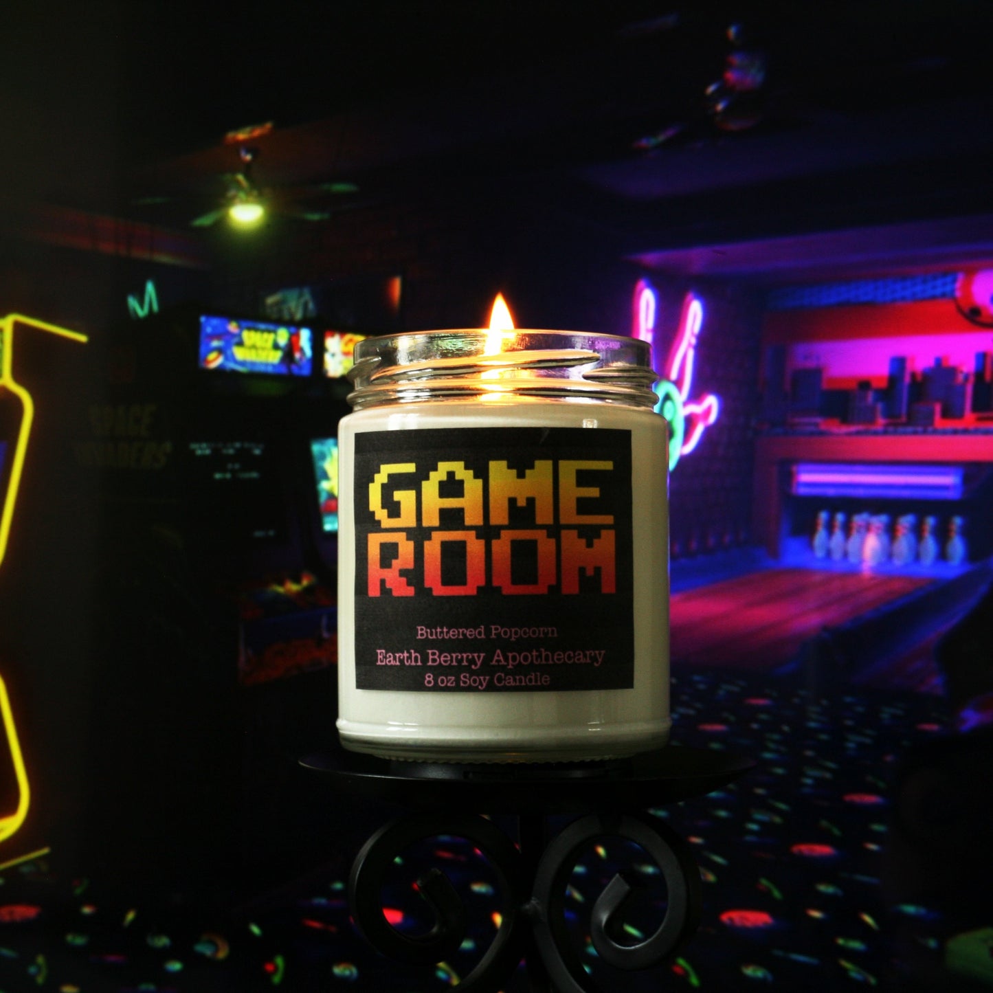 game room candle in front of arcade machines