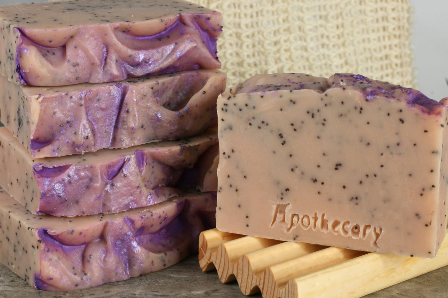 Pink dragonfruit soap with exfoliating poppyseeds and a sparkly purple top